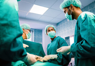 Surgery team operating in a surgical room. Healthcare, people concept